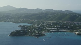 AX103_063 - 4.8K aerial stock footage of Homes nestled in trees around Caribbean blue waters of the bay, East End, St Thomas