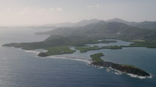 AX103_064 - 4.8K aerial stock footage of Tiny islands in sapphire blue Caribbean waters off the coast, East End, St Thomas