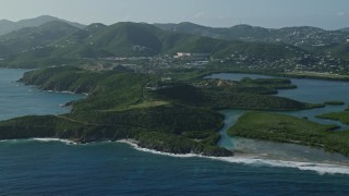 AX103_064E - 4.8K aerial stock footage of tiny islands in sapphire blue Caribbean waters along the shores, East End, St Thomas