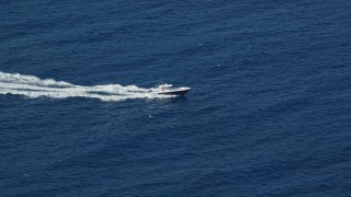 AX103_067 - 4.8K aerial stock footage of a Fishing boat in sapphire blue Caribbean waters, St Thomas
