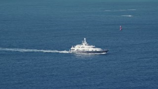 AX103_068 - 4.8K aerial stock footage of a Yacht in sapphire blue Caribbean waters off the coast, St Thomas