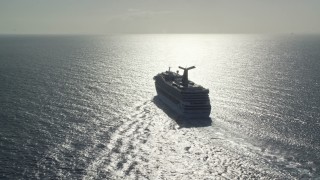 AX103_069 - 4.8K aerial stock footage of a Carnival cruise ship in Caribbean blue waters, St Thomas