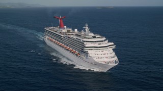 AX103_071 - 4.8K aerial stock footage of a Cruise ship in sapphire blue Caribbean waters off the coast, St Thomas