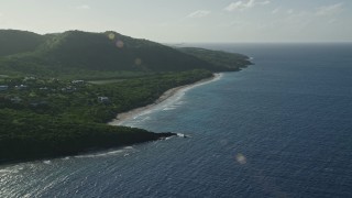 AX103_094 - 4.8K aerial stock footage of Caribbean beach alongside jungle and sapphire blue waters, Culebra, Puerto Rico