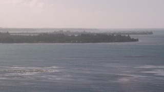 AX103_125 - 4.8K aerial stock footage Approaching an island in blue Caribbean waters, Rio Grande, Puerto Rico