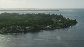 AX103_126E - 4.8K aerial stock footage of island homes with views of Caribbean blue waters, Puerto Rico