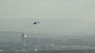 AX103_144 - 4.8K aerial stock footage Tracking a helicopter, Luis Muñoz Marín International Airport, Carolina Puerto Rico