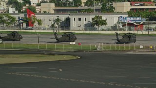 AX103_154 - 4.8K aerial stock footage of Military helicopters at Isla Grande Airport, San Juan