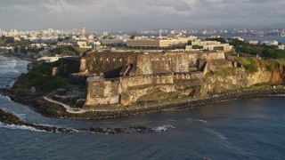 AX104_004E - 4.8K aerial stock footage of Fort San Felipe del Morro, Old San Juan, sunset
