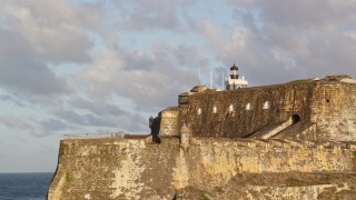 AX104_012 - 4.8K aerial stock footage of Fort San Felipe del Morro, Old San Juan, sunset