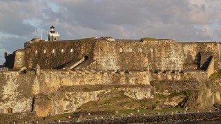 AX104_014E - 4.8K aerial stock footage of Fort San Felipe del Morro, Old San Juan, sunset