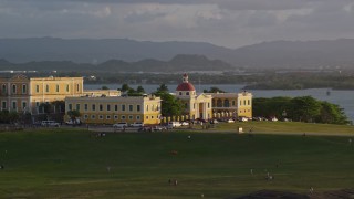 AX104_028 - 4.8K aerial stock footage of Escuela De Artes Plasticas De Puerto Rico, sunset