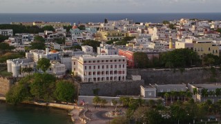 AX104_036E - 4.8K aerial stock footage of La Fortaleza and Caribbean buildings, Old San Juan sunset