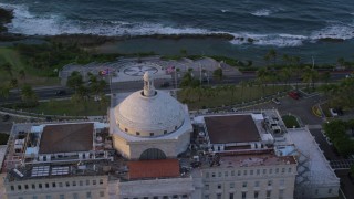 AX104_049 - 4.8K aerial stock footage Circling San Juan Capitol Building, Old San Juan Puerto Rico, sunset