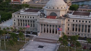 AX104_051E - 4.8K aerial stock footage tilting down on San Juan Capitol Building, Old San Juan, Puerto Rico, sunset