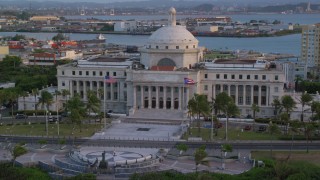 AX104_052 - 4.8K aerial stock footage Tilting down on San Juan Capitol Building, Old San Juan, Puerto Rico, sunset