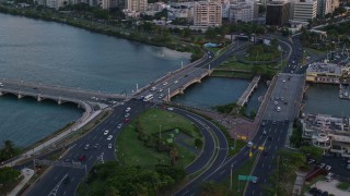 AX104_059 - 4.8K aerial stock footage of Light traffic on bridges in the Caribbean, San Juan, Puerto Rico, sunset