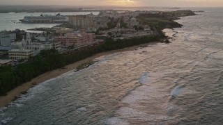 AX104_073E - 4.8K aerial stock footage flyby Normandie Hotel and Estadio Sixto Escobar, approach capitol building, San Juan, Puerto Rico, sunset