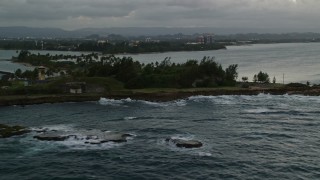 AX104_091E - 4.8K aerial stock footage of Isla de Cabras, San Juan twilight