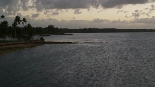 AX104_110 - 4.8K aerial stock footage of the Caribbean coastline along ocean waters, Dorado, Puerto Rico, twilight