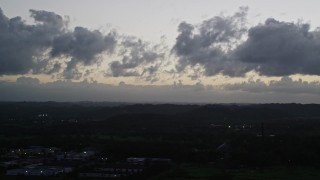 AX104_137 - 4.8K aerial stock footage of Clouds over a Caribbean town, Dorado, Puerto Rico, twilight