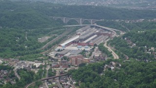 AX105_005 - 4.8K aerial stock footage approaching a large factory, Turtle Creek, Pennsylvania