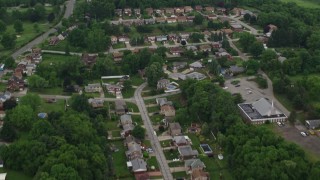 AX105_017E - 4.8K aerial stock footage flying over suburban homes, West Mifflin, Pennsylvania