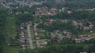 AX105_019 - 4.8K aerial stock footage orbiting hilltop suburban homes, West Mifflin, Pennsylvania