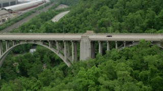 AX105_062 - 4.8K aerial stock footage orbiting, tracking light traffic on George Westinghouse Bridge, East East Pittsburgh, Pennsylvania