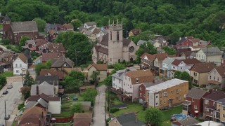 AX105_064E - 4.8K aerial stock footage of a Church and Suburban Homes, East Pittsburgh, Pennsylvania