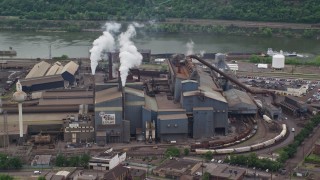 AX105_069E - 4.8K aerial stock footage of flying past the U.S. Steel Mon Valley Works Factory, Braddock, Pennsylvania