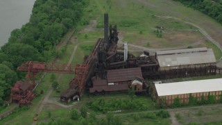 AX105_072 - 4.8K aerial stock footage flying over Carrie Furnace Steel Plant, Pittsburgh, Pennsylvania
