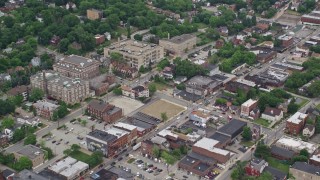 AX105_083E - 4.8K aerial stock footage of homes, apartment buildings, school and small hospital, Pittsburgh, Pennsylvania