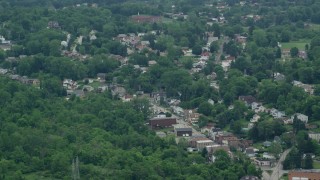 AX105_092 - 4.8K aerial stock footage of homes and shops on a small town road, Penn Hills, Pennsylvania