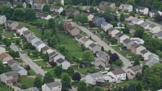 AX105_094E - 4.8K aerial stock footage passing a suburban neighborhood, Penn Hills, Pennsylvania