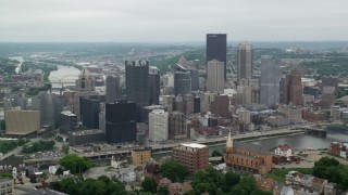 AX105_117 - 4.8K stock footage aerial video orbiting riverfront skyscrapers, Downtown Pittsburgh, Pennsylvania