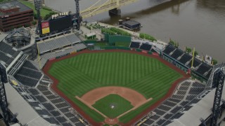 AX105_124 - 4.8K aerial stock footage orbiting PNC Park Tilt Up and Reveal Downtown Pittsburgh, Pennsylvania