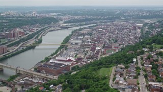 AX105_133 - 4.8K aerial stock footage of a riverfront urban neighborhood, Pittsburgh, Pennsylvania