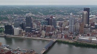 AX105_134E - 4.8K aerial stock footage approaching skyscrapers and flying over Downtown Pittsburgh, Pennsylvania