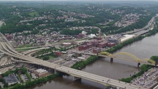 AX105_138E - 4.8K aerial stock footage flying over bridges toward HJ Heinz Plant, Pittsburgh, Pennsylvania