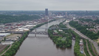 AX105_146 - 4.8K aerial stock footage of a river and skyscrapers, Downtown Pittsburgh, Pennsylvania