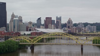 AX105_150E - 4.8K aerial stock footage fly over bridge to approach Convention Center in Downtown Pittsburgh, Pennsylvania