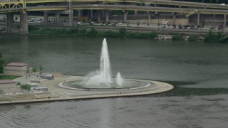 AX105_156 - 4.8K aerial stock footage of a fountain at Point State Park, Downtown Pittsburgh, Pennsylvania