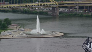 AX105_156E - 4.8K aerial stock footage of a fountain at Point State Park, Downtown Pittsburgh, Pennsylvania