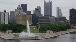 AX105_162E - 4.8K aerial stock footage flying by fountain at Point State Park and Downtown Pittsburgh, Pennsylvania