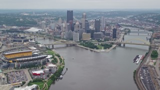 AX105_193E - 4.8K aerial stock footage approaching skyscrapers and rivers, Downtown Pittsburgh, Pennsylvania