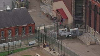 AX105_218 - 4.8K aerial stock footage of Chain Link Fence and Guards at Western State Penitentiary, Pittsburgh, Pennsylvania