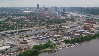 AX105_223E - 4.8K aerial stock footage approaching warehouses near Downtown Pittsburgh, Pennsylvania
