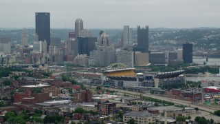 AX105_225 - 4.8K aerial stock footage of Heinz Field Football Stadium and Downtown Pittsburgh Skyline, Pennsylvania