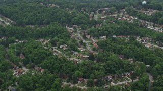 AX105_248E - 4.8K aerial stock footage of flying past a suburban neighborhood, Verona, Pennsylvania